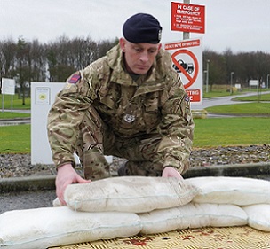 Sometimes flooding can get so bad that the army is brought in to help. Here is a soldier deploying FloodSax alternative sandbags.