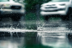 Rainwater flooding a driveway. Photo by Mitchell Griest on free photo website Unsplash.