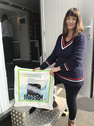 Flood campaigner Mary Dhonau with a pack of 5 FloodSax alternative sandbags