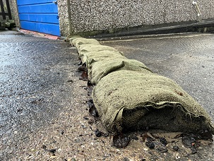 The line of rotting sandbags that were allowing floodwater to get into a pensioner's home