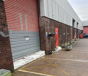 FloodSax alternative sandbags protecting the roller shutter doors at The Welcome Centre warehouse in Huddersfield